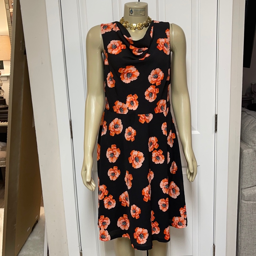 Black sleeveless dress with orange and peach floral prints.